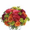 Hot-pink roses and orange ranunculus arranged in a clear glass bubble bowl