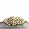 Full casket spray with pale pink and white flowers