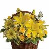 Woven basket filled with bright yellow flowers and greenery.