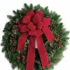 Evergreen wreath decorated with festive ribbons and pinecones.