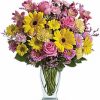 Yellow gerberas and pink flowers in a vase