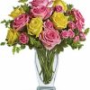 Pink and yellow roses arranged in vase