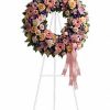 Large pink and peach funeral wreath with roses and lilies