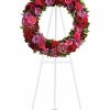Large jewel-toned funeral wreath with roses