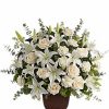 White lilies and cream roses in glass vase