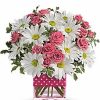 Pink roses and daisies in a polka-dot vase.