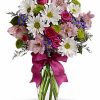 White daisies with pink and purple flowers in a vase