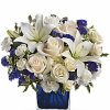 White roses and lilies with blue flowers in vase