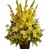 One-sided funeral arrangement with yellow flowers