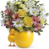 Pastel Easter bouquet with chick accents in a decorative vase.