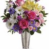Elegant bouquet of fresh flowers arranged with greenery in a vase.