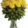 Dozen long-stemmed yellow roses with greenery